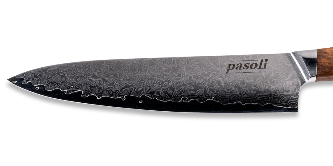 Beautiful grain of the damask blade of our pasoli damask chef's knife including the pasoli logo.